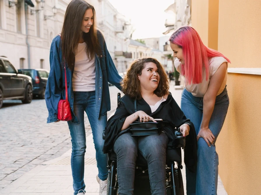disabled women on wheelchair with friends