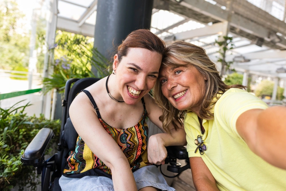 disabled women with an assistant taking a selfie